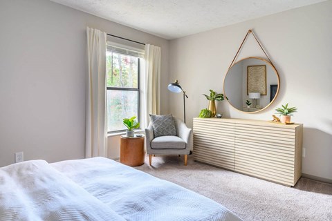 Atria bedroom with sunshine coming through the window at Atria at Crabtree Valley, North Carolina